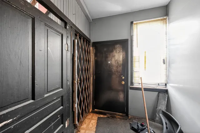 a view of a refrigerator and an entryway