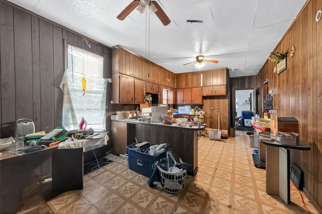 a kitchen with a refrigerator dining table and chairs