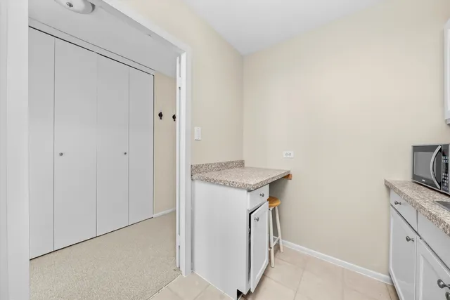 a utility room with cabinets washer and dryer