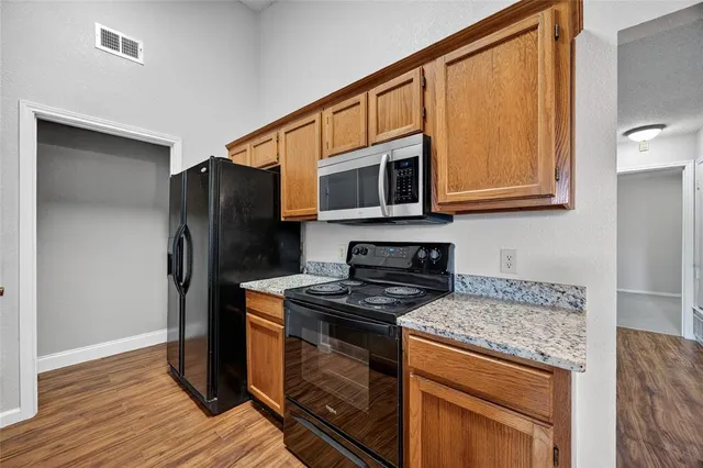 a kitchen with a stove and cabinets