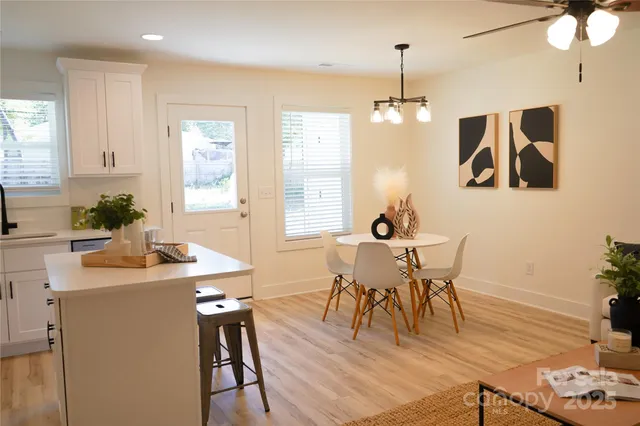 a view of a dining room with furniture window and wooden floor