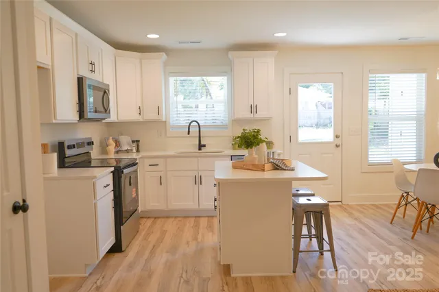 a kitchen with a sink stove and cabinets