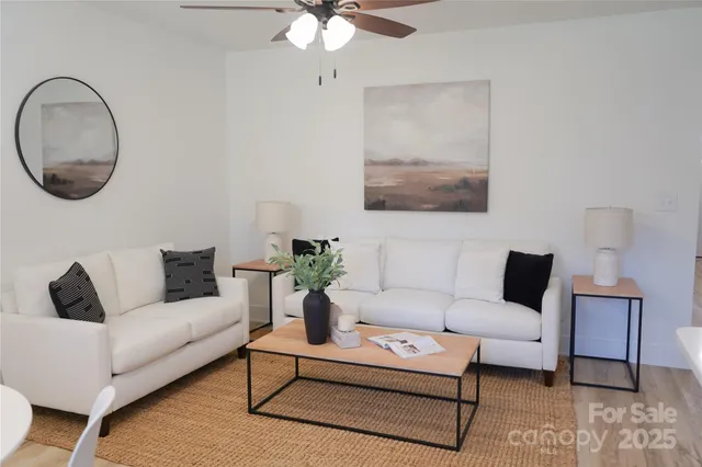 a living room with furniture and a mirror