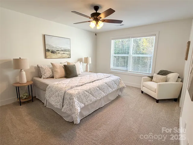 a spacious bedroom with a bed and a couch