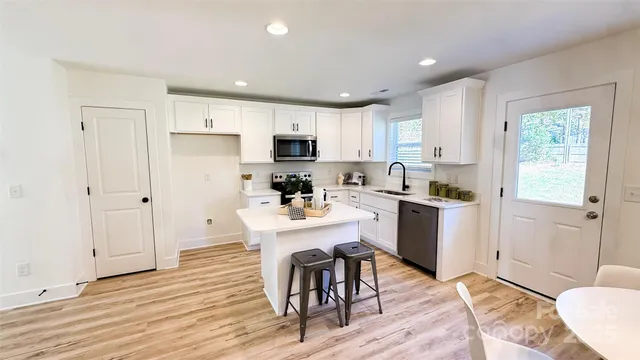 a kitchen with a sink a counter top space and appliances