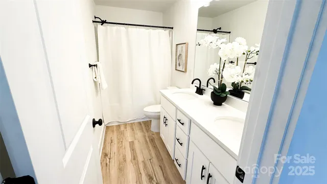 a bathroom with a sink a mirror and shower