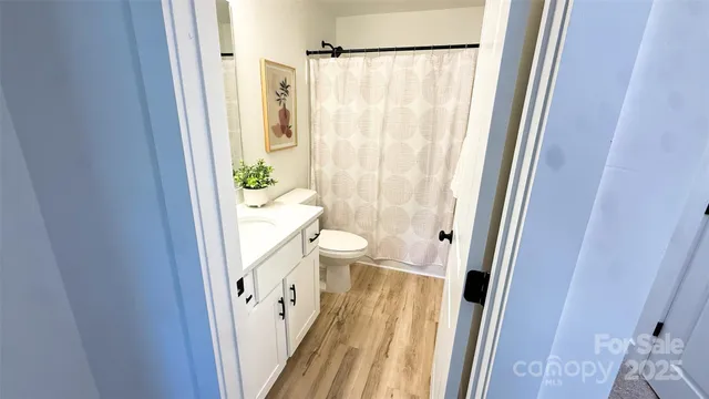 a bathroom with a shower and a toilet