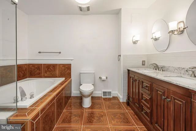 a bathroom with a sink a toilet and a mirror