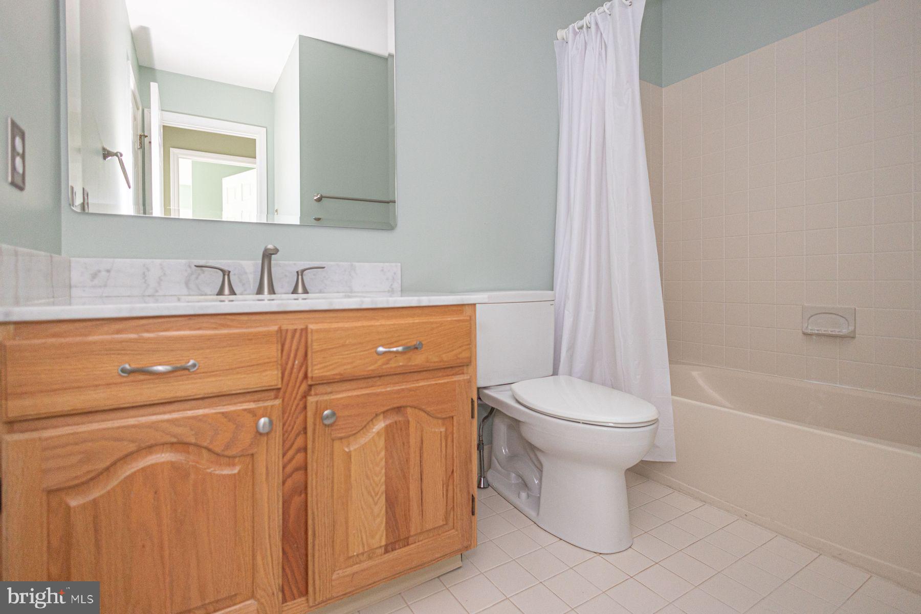 102 Waverly Lane, Unit 4 New Hope, PA 18938 - Photo 23 of 28 a bathroom with a toilet sink and mirror