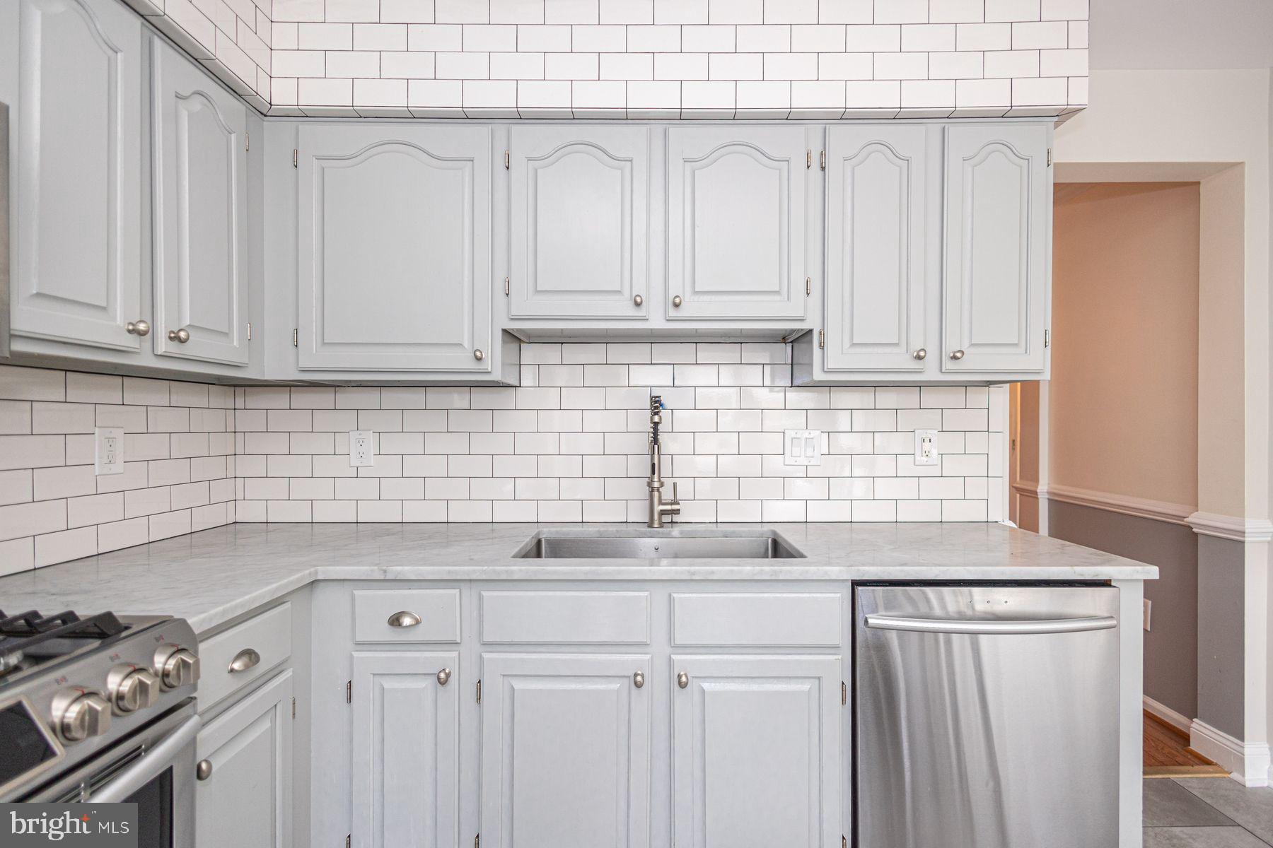 102 Waverly Lane, Unit 4 New Hope, PA 18938 - Photo 6 of 28 a kitchen with stainless steel appliances granite countertop white cabinets and a stove