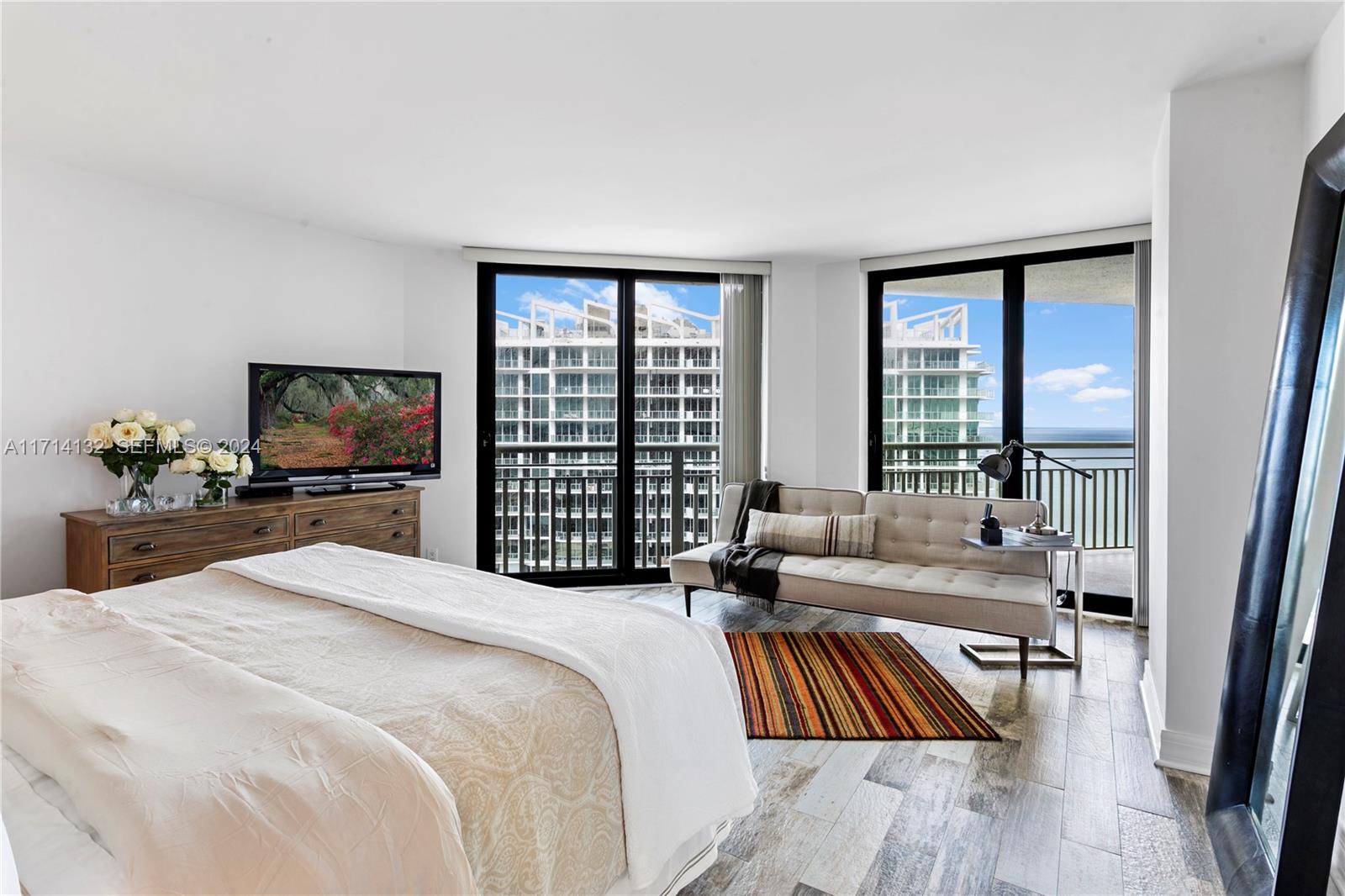 3000 North Ocean Drive, Unit 20A Riviera Beach, FL 33404 - Photo 12 of 43 a bedroom with a bed and a flat screen tv