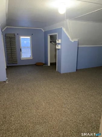 a view of an empty room with a fireplace