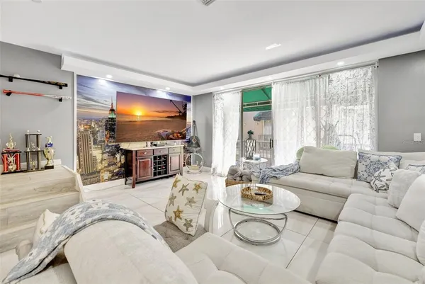 a living room with furniture potted plant and a chandelier