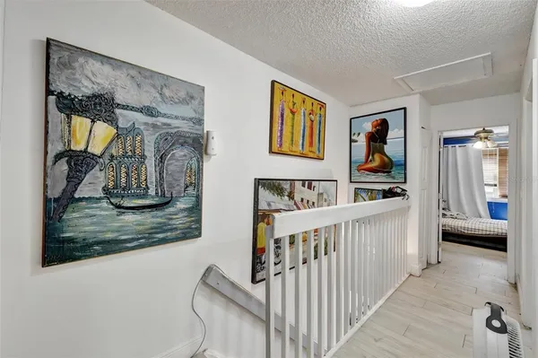 a view of a hallway with furniture and stairs