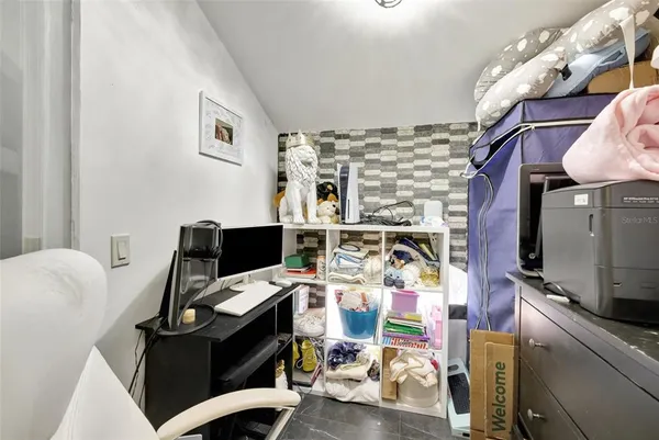 a bedroom with furniture and a book shelf