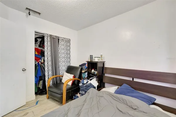 a bedroom with furniture and a flat screen tv