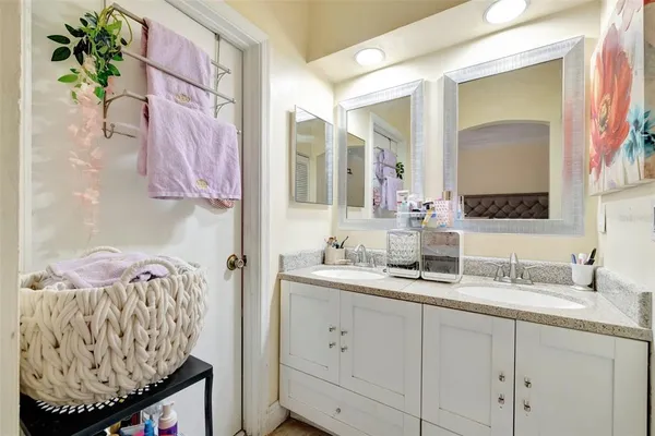 a bedroom with a bed a couch and dresser