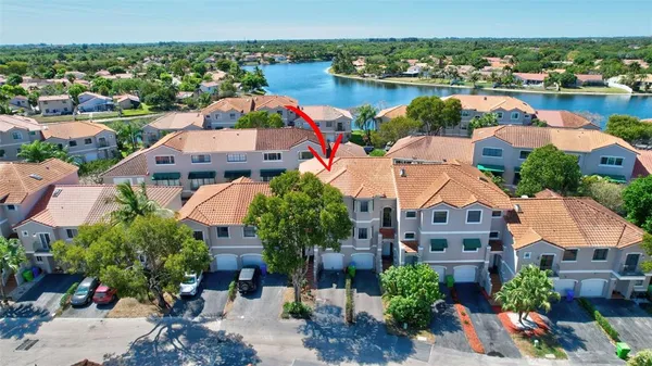 an aerial view of residential houses with outdoor space and river