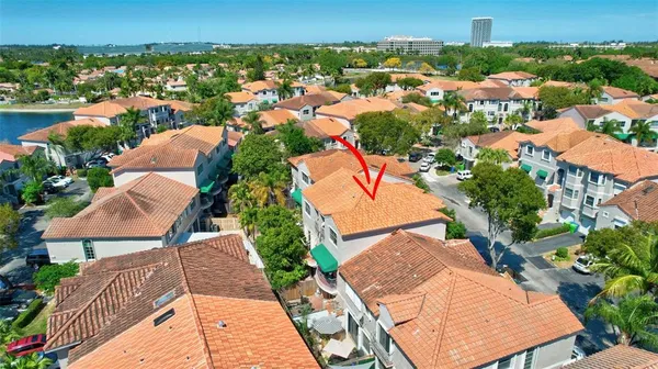 an aerial view of residential houses with outdoor space and trees