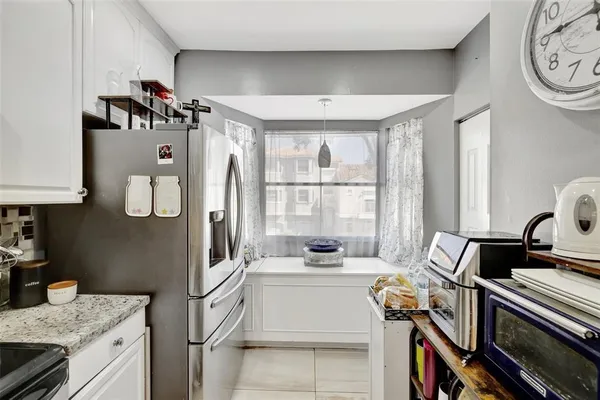 a kitchen with a stove a sink and a microwave