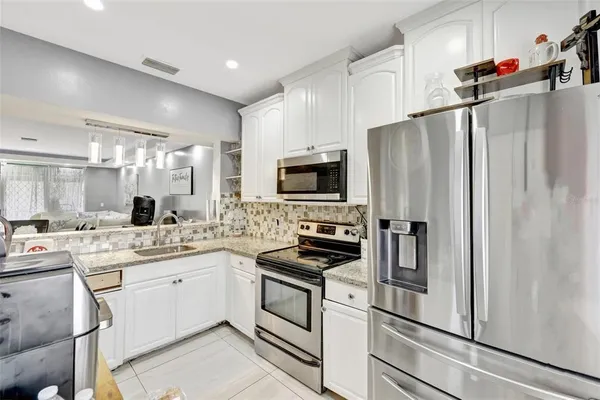 a bathroom with a granite countertop sink a mirror and vanity