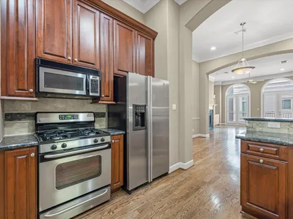 a kitchen with stainless steel appliances granite countertop wooden cabinets a sink and dishwasher