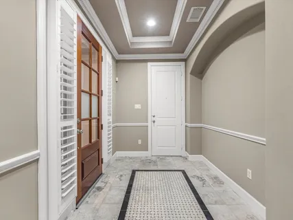an empty room with windows and ceiling fan