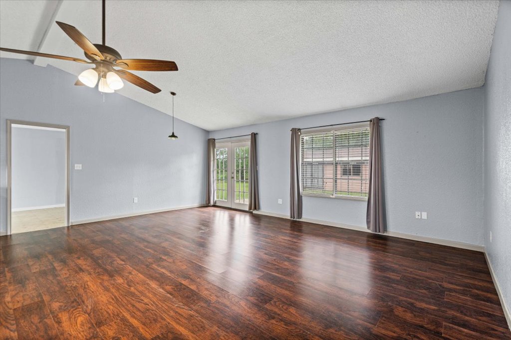 650 West Austin Street Luling, TX 78648 - Photo 3 of 18 Rich hardwood flooring complements a neutral palette in this versatile living space.