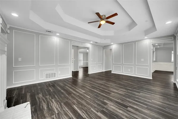 a view of empty room with wooden floor and window