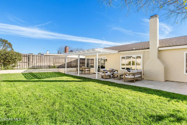 a view of a house with backyard porch and sitting area