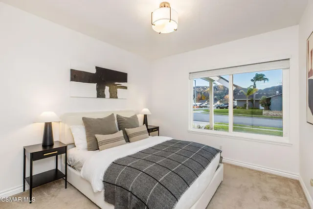 a bedroom with a large bed and a window