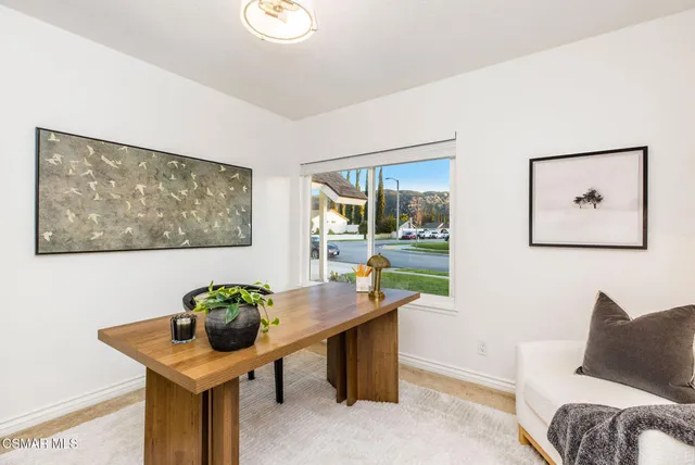 a living room with furniture and painting on the wall