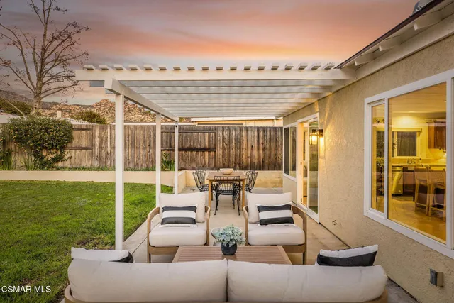 a view of a patio with couches and a big yard