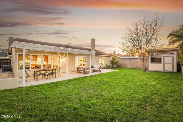a view of a house with backyard porch and sitting area