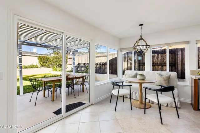 a dining room with furniture a chandelier and fireplace