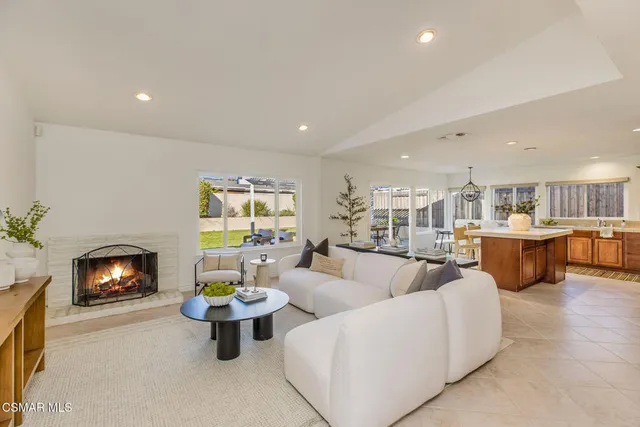 a living room with fireplace furniture and a fireplace