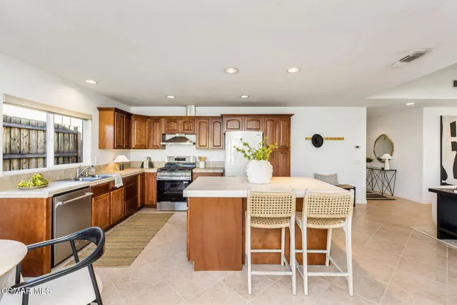 a large kitchen with a table and chairs