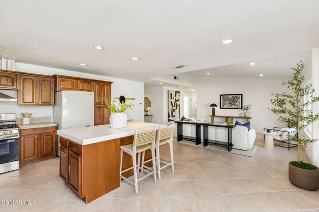 a large kitchen with a table and chairs in it