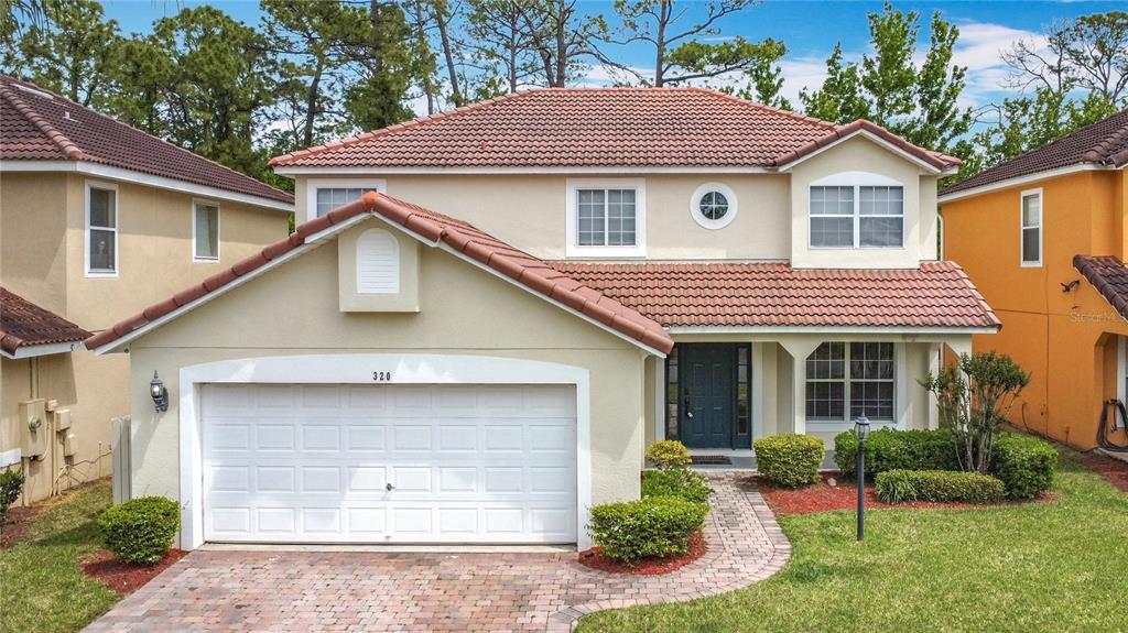 a front view of a house with a yard and garage