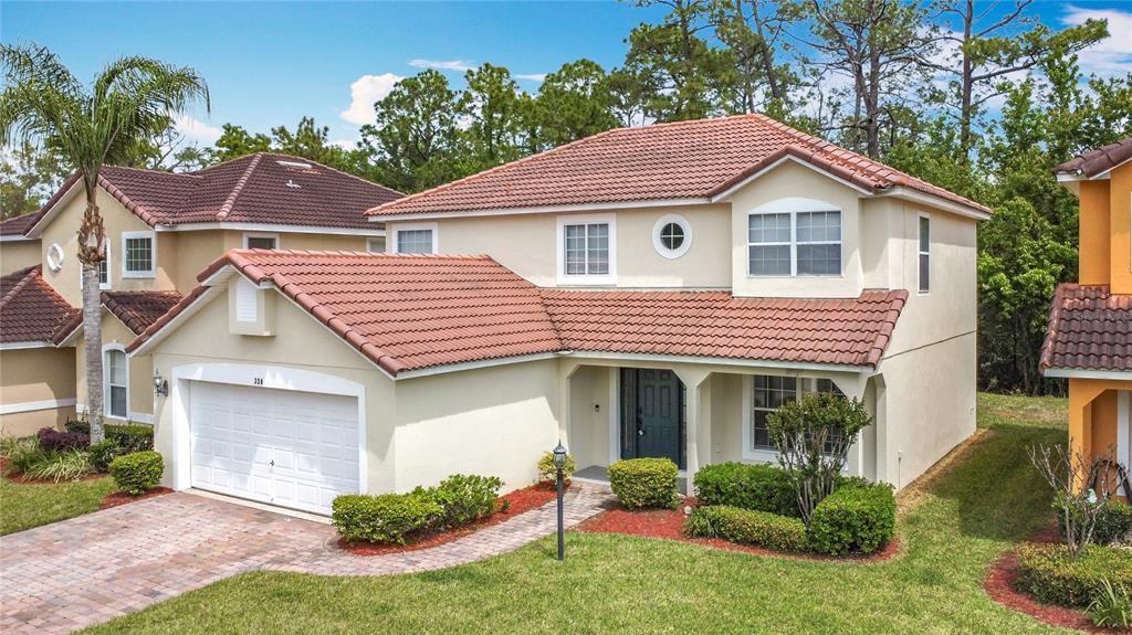 320 Mockingbird Road Davenport, FL 33896 - Photo 2 of 34 a front view of a house with a yard and potted plants