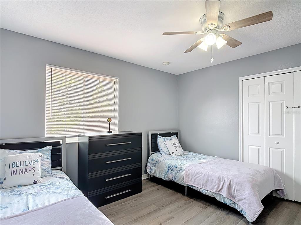320 Mockingbird Road Davenport, FL 33896 - Photo 23 of 34 a bedroom with a bed and a dresser