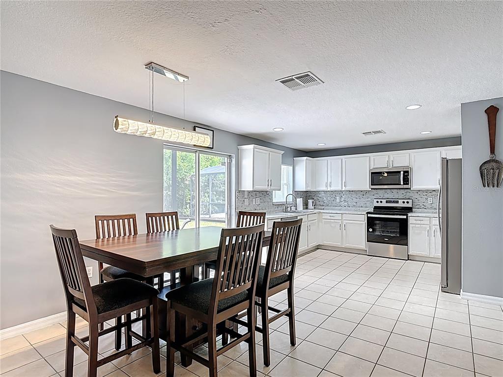 320 Mockingbird Road Davenport, FL 33896 - Photo 8 of 34 a view of a dining room with furniture window and wooden floor