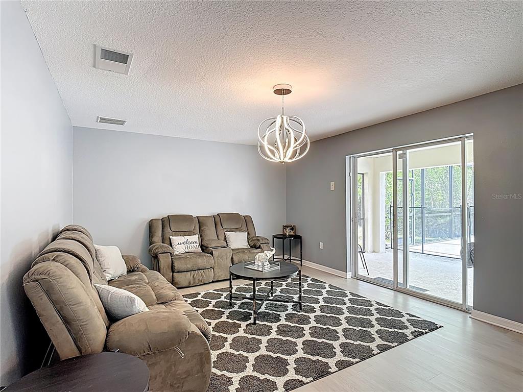 320 Mockingbird Road Davenport, FL 33896 - Photo 10 of 34 a living room with furniture a rug and a window