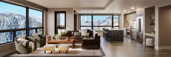 a living room with furniture large windows and wooden floor