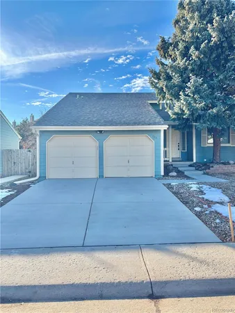 a front view of house with a garage
