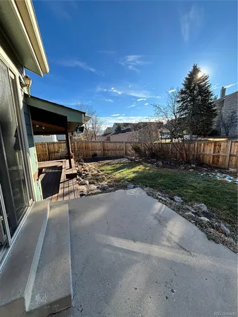 a view of a backyard fountain and a patio
