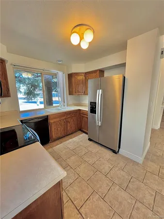a kitchen with stainless steel appliances a refrigerator sink and cabinets
