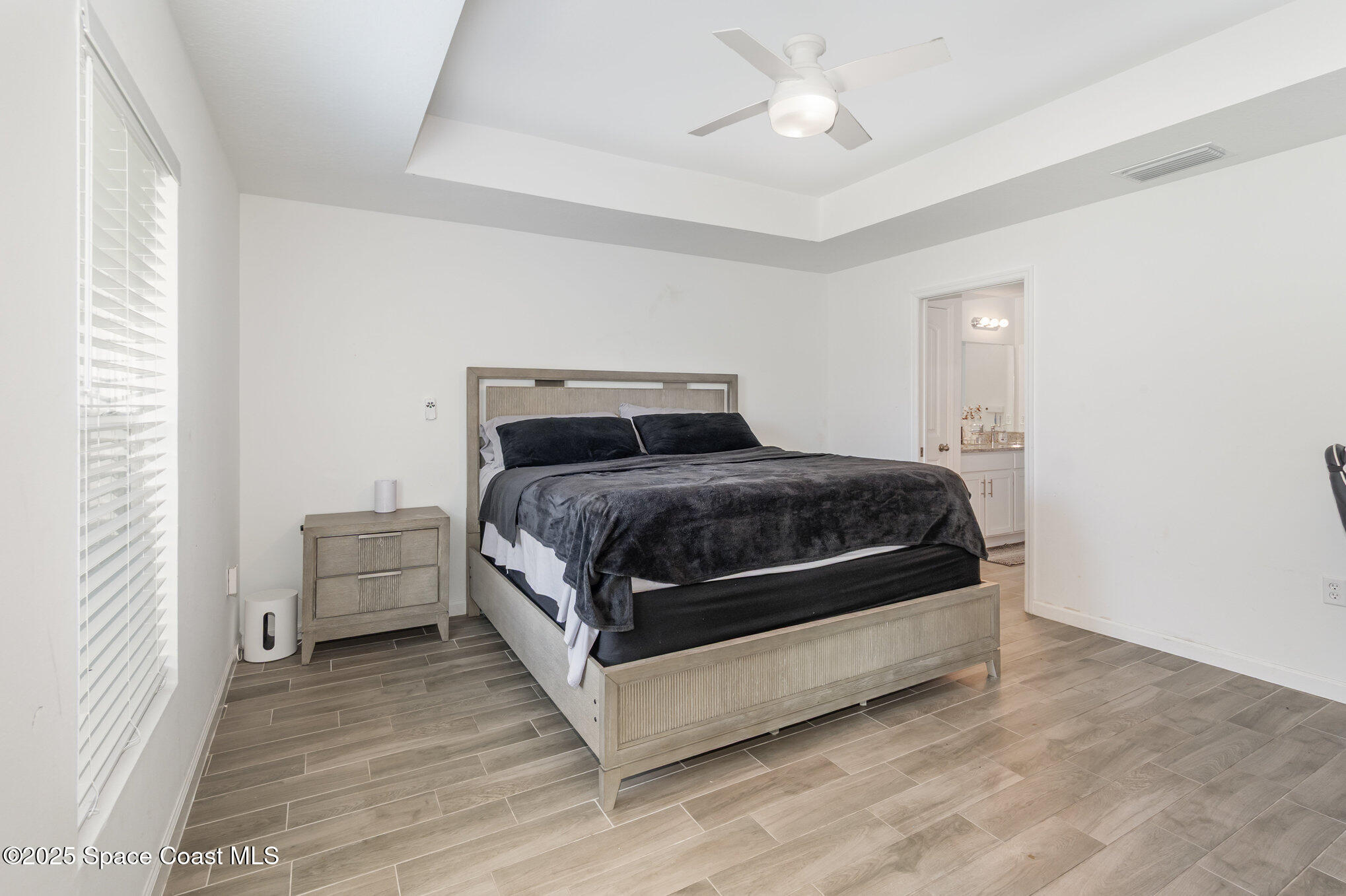 1534 Pine Street Orlando, FL 32824 - Photo 24 of 31 a bedroom with a bed and a chandelier fan