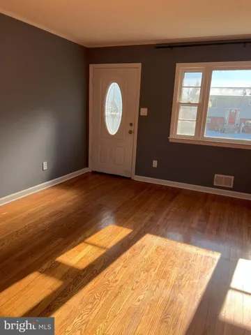 a view of wooden floor and windows in a room