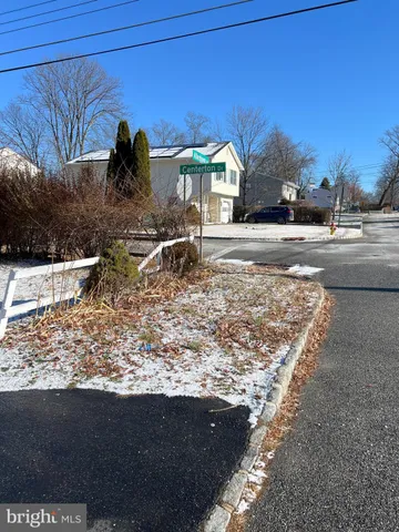 a view of road with large trees